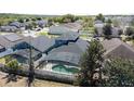 Aerial shot of the backyard, highlighting the screened-in pool at 4411 Great Harbor Ln, Kissimmee, FL 34746