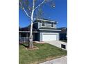 Charming two-story home featuring a two-car garage, well-manicured lawn, and mature trees at 4411 Great Harbor Ln, Kissimmee, FL 34746