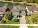 Spacious two-story house with a serene pond view, complemented by lush greenery and well-maintained landscaping at 4842 Rockvale Dr, Kissimmee, FL 34758