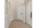 Inviting entryway with neutral paint, tile flooring, and decorative architectural details at 5201 Lake Hinden Cv, St Cloud, FL 34771