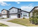 Lovely two-story home features a garage, manicured lawn, and welcoming front entrance at 6592 Taxiway Cir, Orlando, FL 32822