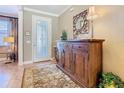 Inviting foyer with decorative mirror, stylish console table, and a view of the front door at 759 Villa Park Rd, Poinciana, FL 34759