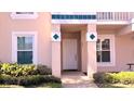 Close up of condo entrance and landscaping, showing the unit number and front door at 13840 Timberbrooke Dr # 103, Orlando, FL 32824