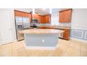 Spacious kitchen featuring granite countertops, stainless steel appliances, a center island, and ample cabinets at 1061 Citrus Landings Blvd, Davenport, FL 33837
