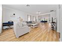Bright and spacious living room featuring wood floors, crown molding, and an open layout at 10937 Prairie Hawk Dr, Orlando, FL 32837