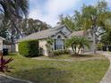 Well-maintained single-story home with lush landscaping and an attached two-car garage at 12113 Calaboose Ct, Orlando, FL 32828