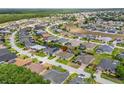 Aerial view of a residential neighborhood featuring neatly arranged houses with lush greenery at 152 Moscato Dr, Davenport, FL 33897