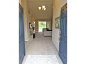 Inviting foyer featuring high ceilings, tile floors, and a view into the spacious living area at 152 Moscato Dr, Davenport, FL 33897