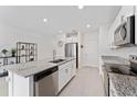 Well-equipped kitchen features an island, stainless appliances, and ample counter space at 1536 Mirabella Cir, Davenport, FL 33897