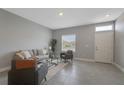 Bright living room with a large window, modern furnishings, and neutral tones create a calming atmosphere at 1787 Coriander Dr, Kissimmee, FL 34759