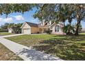 Inviting single-Gathering home with a lush front lawn and mature shade trees at 1916 Nicholas Pl, St Cloud, FL 34771