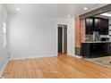 Bright living room featuring wood floors and an exposed brick accent wall at 2320 Amherst Ave, Orlando, FL 32804