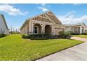 One-story home with well-maintained lawn and manicured landscaping, set against a bright blue sky at 2658 Meadowedge Loop, St Cloud, FL 34772