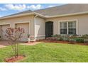 Landscaped home exterior features a well-maintained lawn and a two car garage at 2885 Attwater Loop, Winter Haven, FL 33884