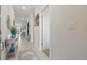 Bright hallway with tiled floors leads to an open living space at 2885 Attwater Loop, Winter Haven, FL 33884