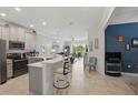 Open kitchen boasts modern appliances and a breakfast bar at 2885 Attwater Loop, Winter Haven, FL 33884