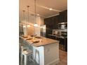 Modern kitchen with granite counters, stainless steel appliances and eat-in island with seating at 2926 Siesta View Dr, Kissimmee, FL 34744