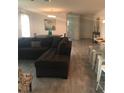 Open floor plan shows living room with dark couch that connects to kitchen and dining room at 2926 Siesta View Dr, Kissimmee, FL 34744