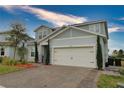 Charming two-story home showcasing a covered entry, attached two-car garage, and craftsman design details at 3262 Hanging Tide St, Winter Garden, FL 34787
