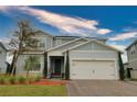 Charming two-story home showcasing a covered entry, attached two-car garage, and craftsman design details at 3262 Hanging Tide St, Winter Garden, FL 34787