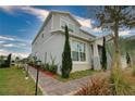Charming two-story home showcasing landscaped front yard, attached two-car garage, and craftsman design details at 3262 Hanging Tide St, Winter Garden, FL 34787