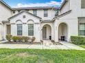 Inviting townhouse exterior with manicured lawn, garden beds, and a covered entryway showcasing the address at 426 Captiva Dr, Davenport, FL 33896