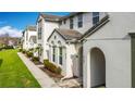 Charming townhouses featuring well-kept landscaping and covered entrances, set along a tidy sidewalk and green lawn at 426 Captiva Dr, Davenport, FL 33896