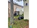 Exterior side yard view showing AC unit, black trash bag and fence at 4406 Hidden Meadow Dr, Kissimmee, FL 34746