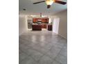 Open-concept kitchen with stainless steel appliances and tile flooring at 4710 Willoughby St, Kissimmee, FL 34758