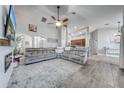 Spacious living room featuring wood flooring and a large comfortable sectional at 4740 Cypress Forest Ln, St Cloud, FL 34772