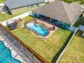 Aerial view of a fenced in pool, trampoline and playground set in backyard at 4740 Cypress Forest Ln, St Cloud, FL 34772