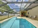 Relaxing screened-in pool with plenty of patio space for lounge chairs and entertaining in a private backyard at 532 Kildrummy Dr, Davenport, FL 33896