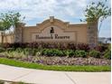 Elegant stone sign displaying the 'Hammock Reserve' community name surrounded by lush landscaping at 5539 Maddie Dr, Haines City, FL 33844