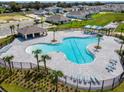 Resort-style pool area with palm trees, lounge chairs, and shaded cabanas in a serene community setting at 5539 Maddie Dr, Haines City, FL 33844