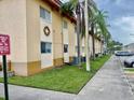 Exterior view of a condo with palm trees and a visitor parking sign at 731 Wyman Ct # 731-A, Orlando, FL 32809