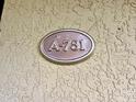 Close-up of an apartment number plaque with the unit number 