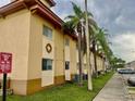A condo with palm trees along the walkway and exterior design elements at 731 Wyman Ct # 731-A, Orlando, FL 32809