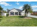 Beautifully landscaped front yard featuring a charming one story home with stone accents and a two-car garage at 784 Seneca Trl, St Cloud, FL 34772