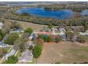 An aerial view showcases this property's convenient location near a beautiful lake and surrounding community at 834 High Pointe Cir, Minneola, FL 34715