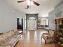 Inviting living room featuring tile floors, a ceiling fan and traditional furnishings at 834 High Pointe Cir, Minneola, FL 34715