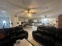 View of the living room featuring tile floors, ceiling fan, and open kitchen area at 837 Quintilian Ave, Orlando, FL 32809