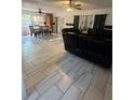 Shows the living room area with dining table, and ceramic flooring in the home at 837 Quintilian Ave, Orlando, FL 32809
