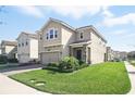 Exterior view of a two-story home with a brick paved driveway and landscaped front yard at 1107 Trappers Trail Loop, Davenport, FL 33896