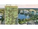 Gorgeous aerial view of high-rise residential building overlooking a lake and featuring serene, green surroundings at 150 E Robinson St # 219, Orlando, FL 32801