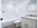 Well-lit bathroom with a tub and shower combo, modern fixtures, and a granite-topped vanity at 1706 3Rd Ave, Deland, FL 32724