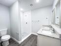 Modern bathroom with a stand-up shower, double vanity, granite counters, and contemporary fixtures at 1706 3Rd Ave, Deland, FL 32724