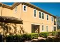 Two-story home with screened-in patio, and manicured hedges at 17459 Chateau Pine Way, Clermont, FL 34711