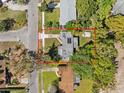An aerial view showcasing the home's roof, driveway, and surrounding mature trees at 1921 Taylor Ave, Winter Park, FL 32792