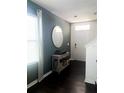 Welcoming entryway featuring dark floors, a round mirror, and an accent table at 1943 Fountains Dr, Kissimmee, FL 34744
