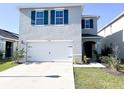 Charming two story home featuring blue shutters and a well maintained front lawn at 1943 Fountains Dr, Kissimmee, FL 34744